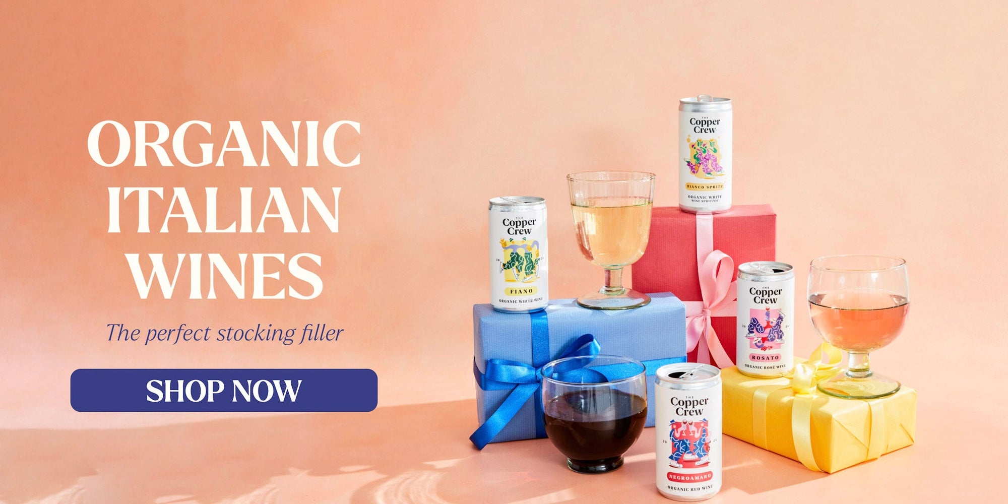 Organic Italian wines with gift boxes and glasses on a peach background