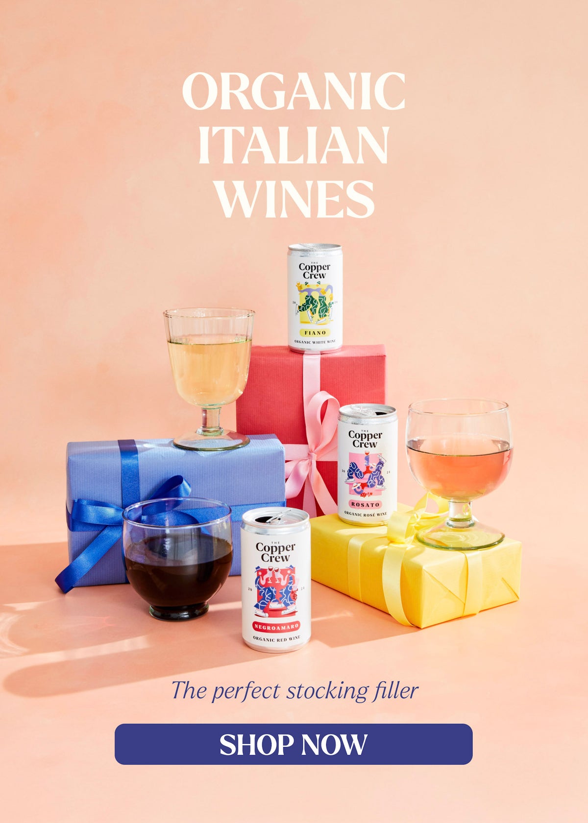 Organic Italian wines with gift boxes and glasses on a peach background